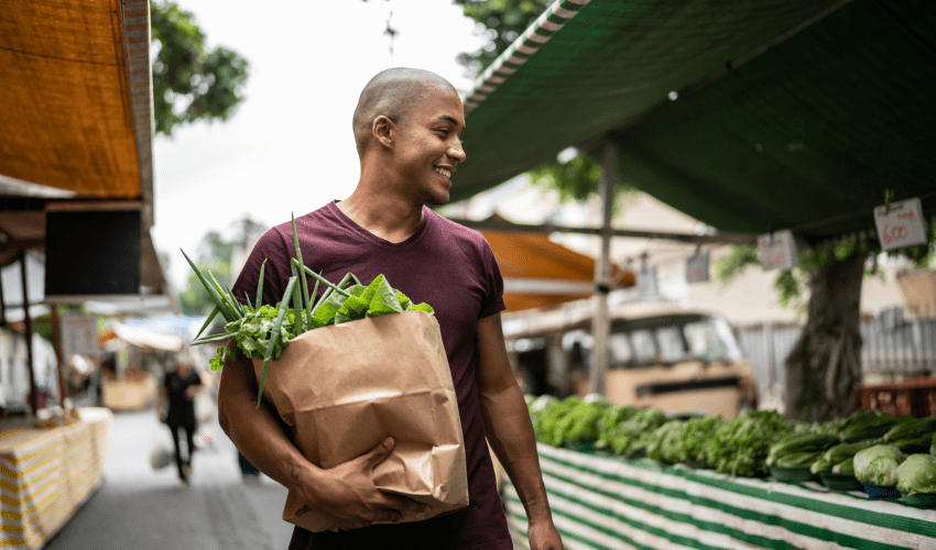 Homem escolhendo alimentos saudaveis na feira